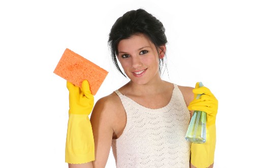 Cleaner tackling a kitchen deep clean in Battersea